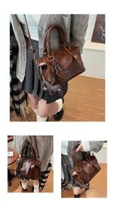 Detail view of deep brown vintage Boston bag with glossy finish and cute mouse charm