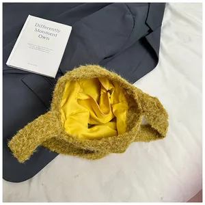Close-up of mustard yellow fleece tote bag showing internal zipper pocket and soft lining