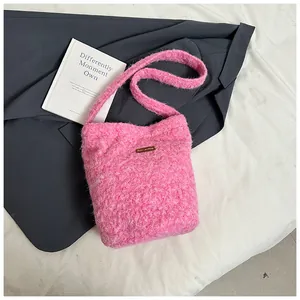 Detailed close-up of pink faux fur texture and leather patch on soft plush tote bag