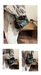 Detail of vintage black patent leather bag with chocolate and dachshund charms