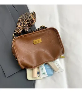 Internal view of the brown Boston bag showing large capacity for phone and cosmetics