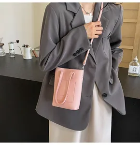 Close-up of pink litchi texture leather mini crossbody bag shown on a model