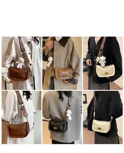 Detail view of stylish half-moon crossbody bag in various colors with leopard print strap