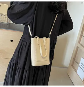 Detail of cream pebbled leather mini crossbody phone bag with fashion logo embossing