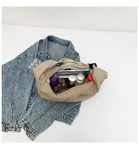 Detail view of khaki nylon hobo bag showing large storage capacity for tablets and cosmetics