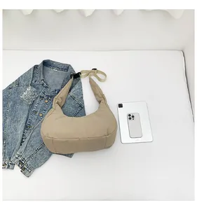 Detailed view of beige quilted nylon puffer tote bag shown with tablet for size reference