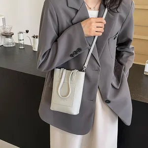Minimalist light grey leather mini crossbody phone bag with textured lychee grain finish