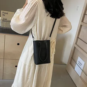 Mini black textured leather crossbody phone bag with adjustable strap and handles