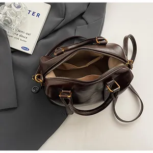 Top view of retro brown Boston bag showing spacious interior lining and pockets