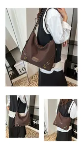 Detail view of large dark coffee tote bag with pleated texture and gold hardware accents
