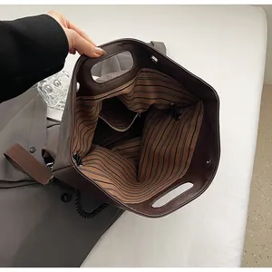 Détail de l'intérieur du grand sac cabas marron avec doublure rayée et boucle aimantée