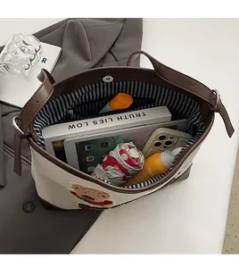 Interior view of canvas tote bag showing large capacity for tablet and daily items