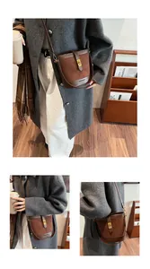 Détail du sac seau vintage en daim marron avec fermoir doré et bandoulière en cuir