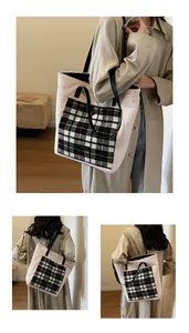 Detail of white plush tote bag featuring a black and white plaid pocket with gold threads