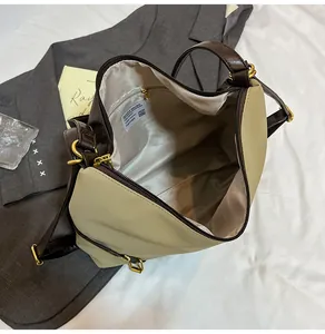 Interior view of the large tote bag showing a light grey lining and a zippered pocket