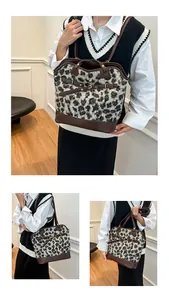 Detail of leopard print tote bag featuring brown leather trim and gold metal buckle accents