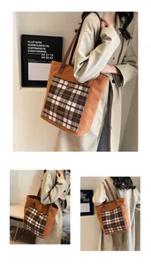 Detail of plush tote bag showing ginger fabric and brown plaid pocket with logo