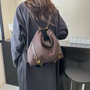 Large dark brown pleated tote backpack with premium leather straps and gold metal hardware
