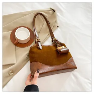 Detail of vintage brown bucket bag with mini coin purse on beige suit with coffee cup