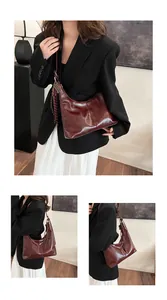 Detail view of burgundy leather hobo bag with tassel showing front and side profile on model