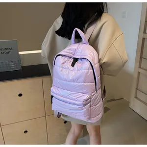Quilted lavender puffer backpack featuring padded texture and adjustable straps shown on model