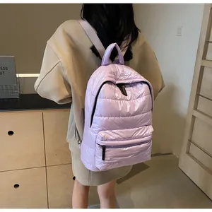 Rear view of model wearing a light purple quilted puffer backpack with large capacity