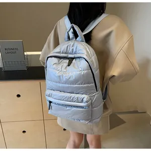Macro detail of the light blue quilted padded backpack featuring premium satin finish