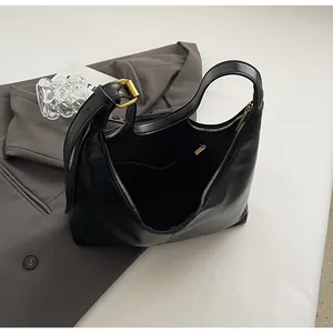 Detail of hobo shoulder bag showing spacious interior compartment and gold zipper