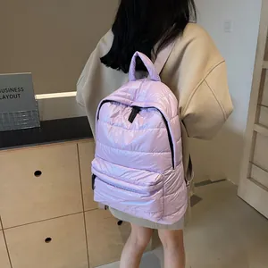Padded lavender quilted backpack with waterproof glossy finish shown on model in cozy interior