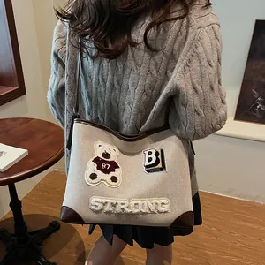 Retro canvas tote bag with bear chenille patches and leather trim for daily commute