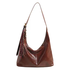 Minimalist brown faux leather hobo bag with tassel charm for women, 2025 fashion style