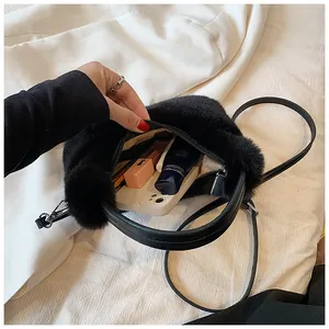 Detail of black faux fur plush bag showing interior storage capacity for essentials