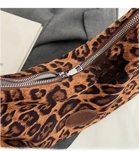 Detail view of the smooth silver zipper and leopard print fabric on a stylish tote bag