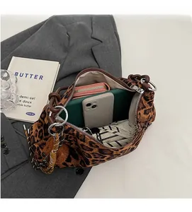 Top view of spacious leopard print tote bag interior holding phone wallet and umbrella