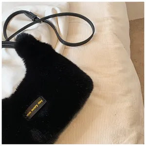 Detail of plush faux fur texture on black shoulder bag with Love Every Day leather patch