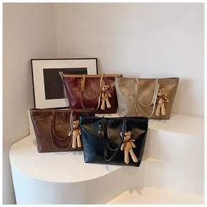 Detailed view of large capacity tote bags in four colors with cute plush bear charms