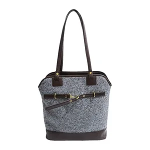 Vintage grey tweed tote bag with brown leather trim and gold buckle in a minimalist style