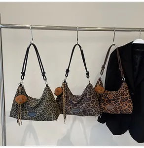 Detailed view of leopard print hobo tote bags in three colors with plush bear charms