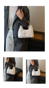 Detailed view of fluffy white faux fur handbag featuring love every day woven label decoration