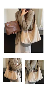 Detail of minimalist beige suede hobo bag with brown leather trim and matching inner pouch