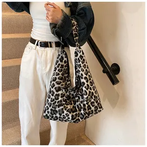 Macro view of leopard print hobo bag showing soft faux fur texture and large capacity