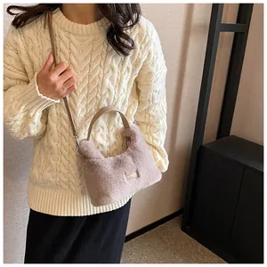 Plush faux fur handbag in soft mauve, styled with a chunky knit sweater for winter