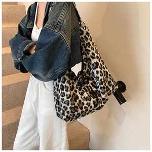 Detail of soft leopard print tote bag featuring black decorative side drawstring closure