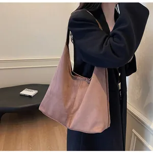Detailed texture of dusty pink frosted suede tote bag with seamless shoulder strap