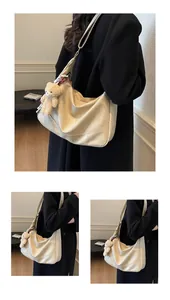 Detail of off-white PU leather tote with plush bear charm and decorative silk scarf