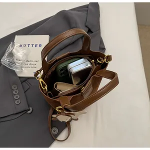Internal view of brown textured leather bucket bag showing large storage capacity