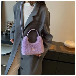 Detail of light purple faux fur crossbody bag with adjustable strap and decorative tag
