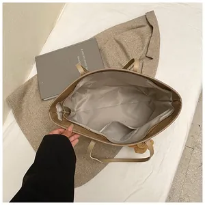 Top view of large beige tote bag showing internal zipper pocket and spacious interior