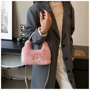 Pink faux fur handbag detail with 'Love every day' tag and leather shoulder strap