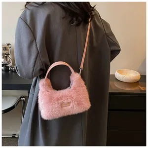 Detail showing plush pink faux fur texture and 'love every day' woven label on the bag